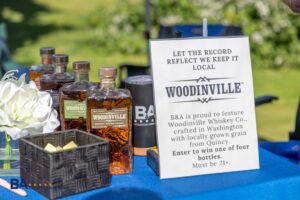 Bottles of Woodinville Whiskey on display for B&A's giveaway at the TPCBA golf tournament