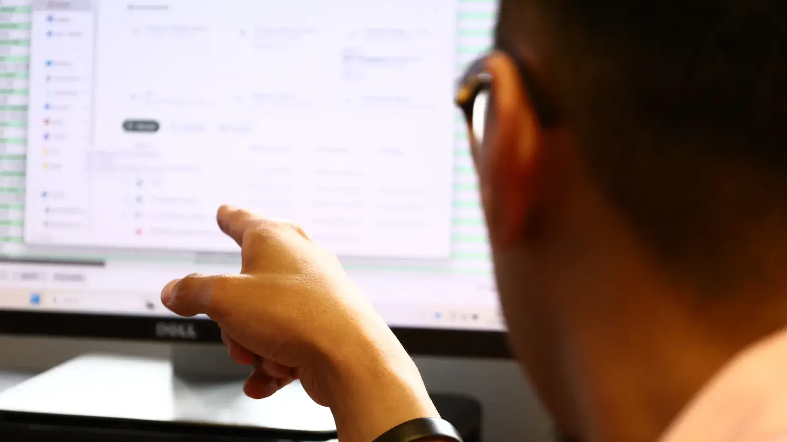 A B&A staff member pointing to a document on a monitor
