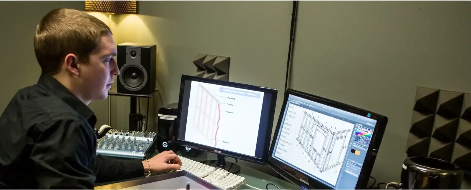 Video editor at a two-monitor editing workstation