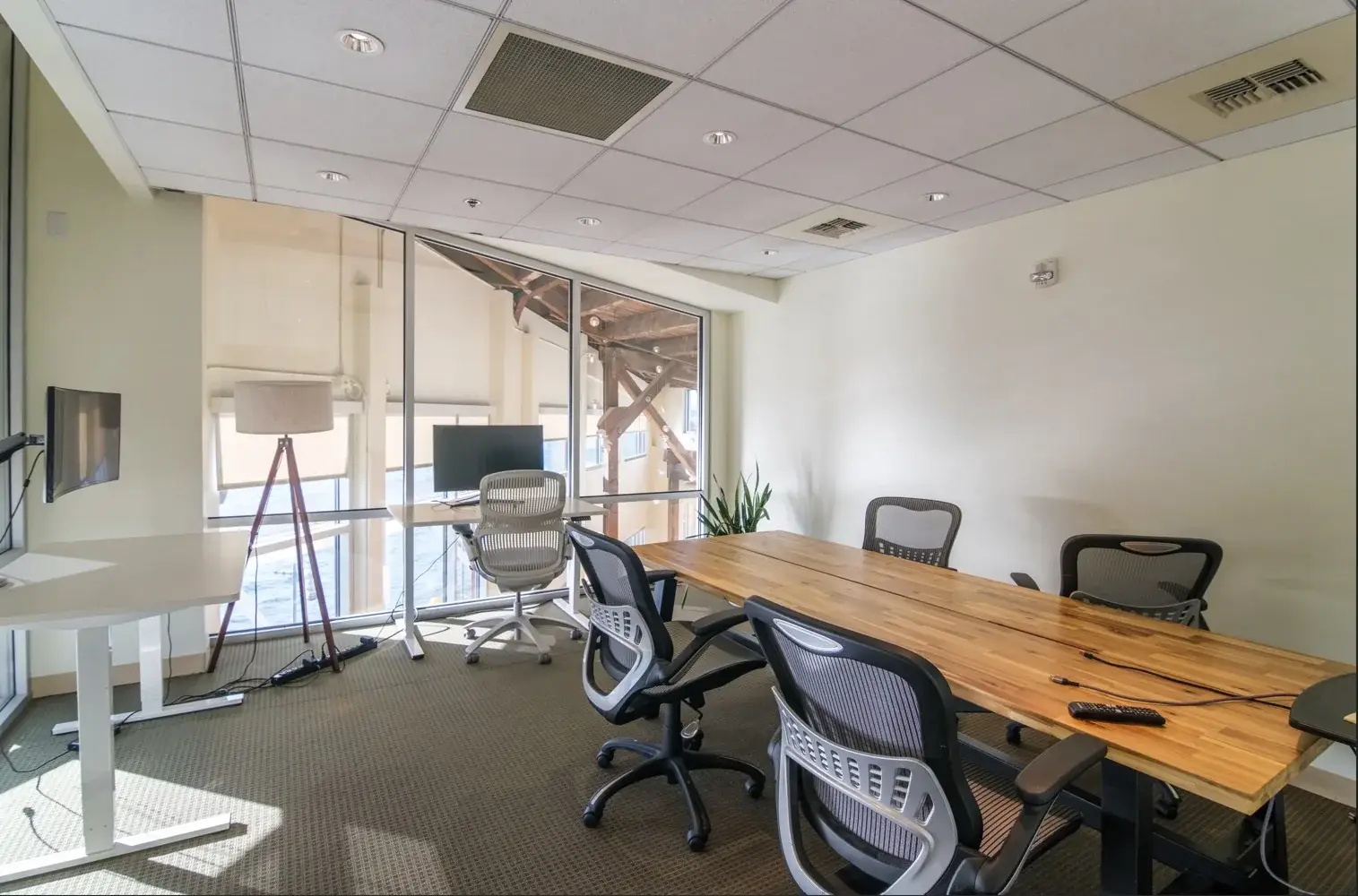 Small conference room at B&A’s Seattle office, with a wood-top table and a mounted monitor